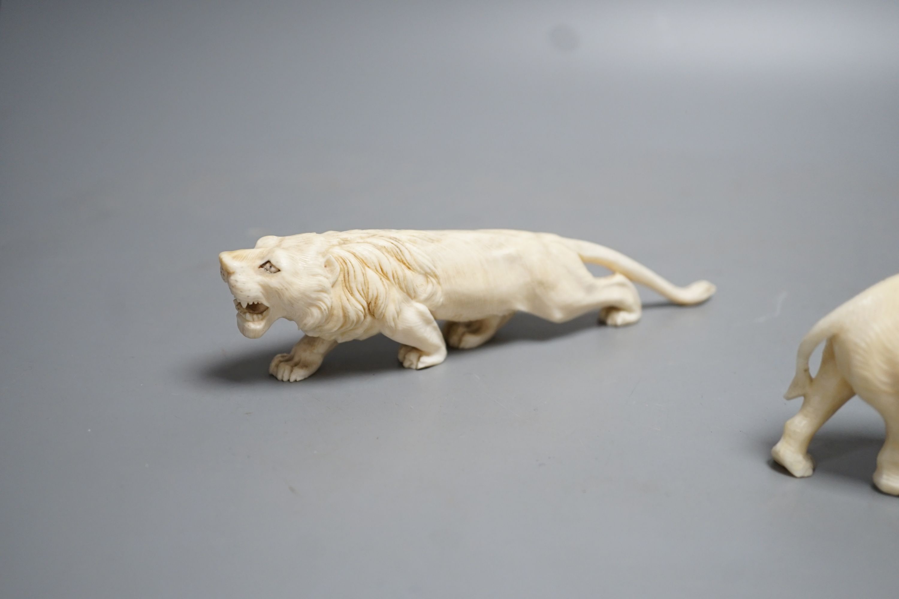 A Japanese Ivory model of an elephant and a similar Ivory model of a lion, early 20th century (2) lion 17cm long